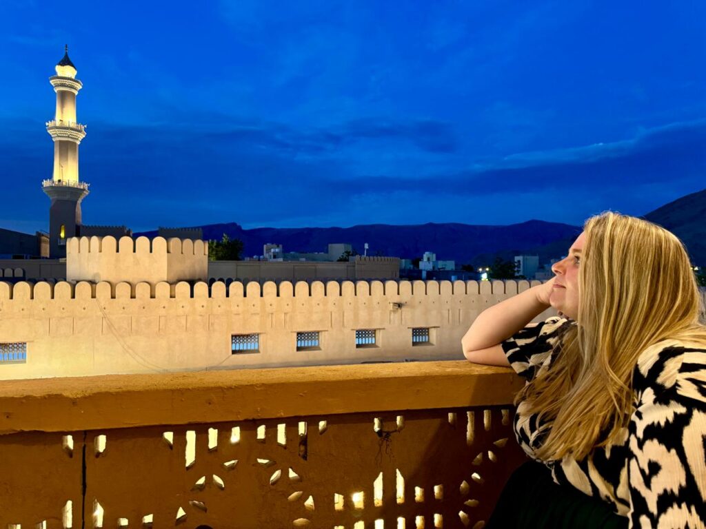 Solo Female Travel in Oman, Woman overlooking Nizwa Fort
